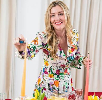 Lady in floral dress lighting candles
