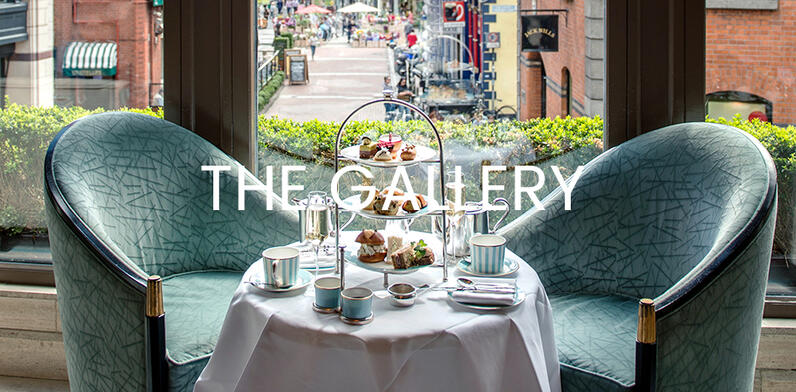 Blue armchairs and table set for tea on The Gallery 