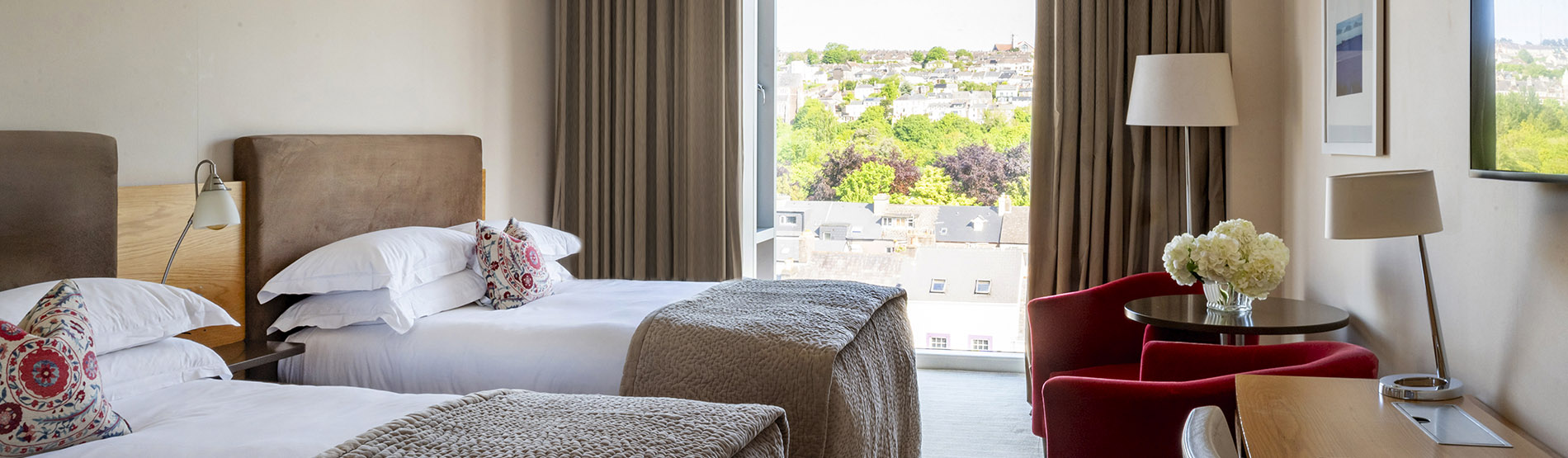 Bright guest room at The River Lee, Cork, with two single beds and modern decor, perfect for a comfortable stay.