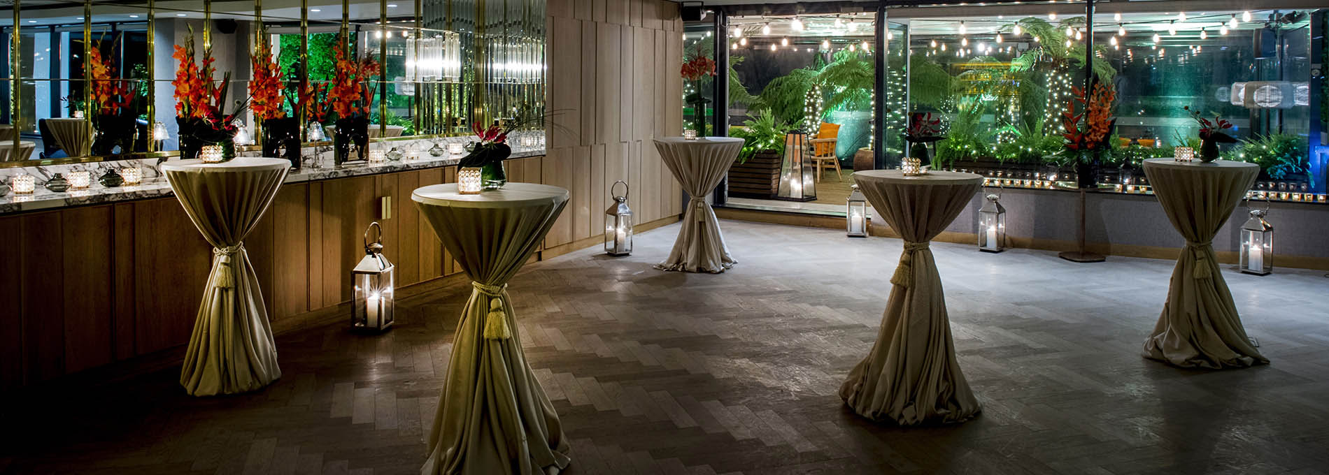 Cocktail Reception set up with tall tables, candles and flowers